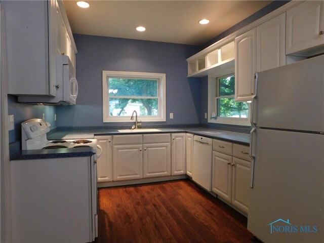 kitchen featuring sink, dark hardwood / wood-style flooring, white appliances, and white cabinets