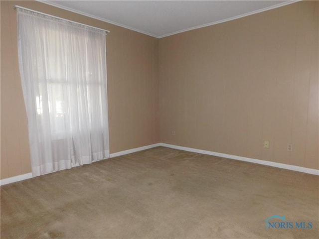 carpeted empty room with baseboards and ornamental molding