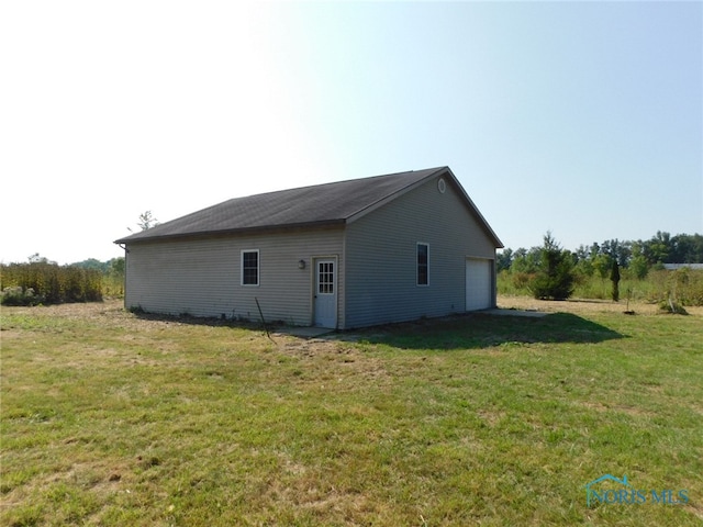 view of home's exterior with a yard and a garage