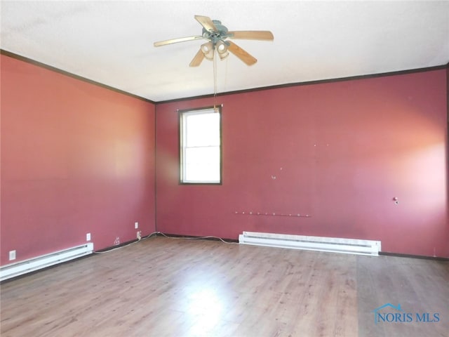 spare room with ceiling fan, crown molding, hardwood / wood-style floors, and a baseboard radiator