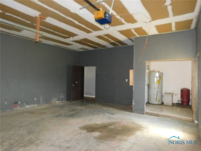 garage featuring a garage door opener and water heater