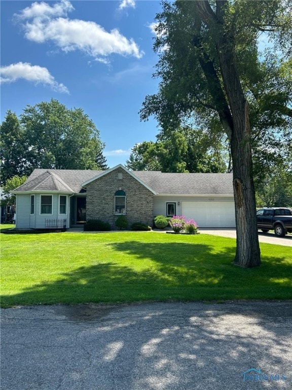 single story home with a garage and a front yard