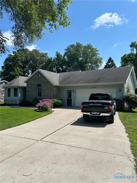 ranch-style house with driveway, a front yard, and a garage