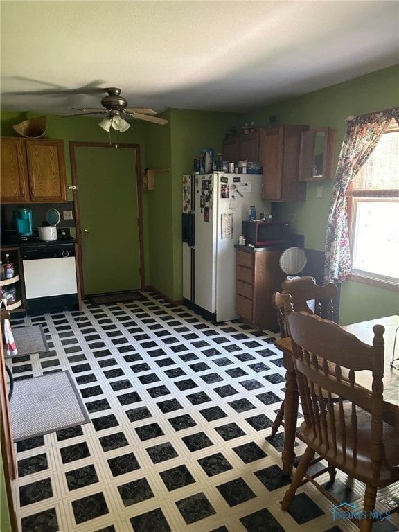 kitchen featuring ceiling fan, tile patterned floors, and white appliances