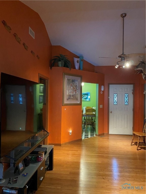 living room featuring light hardwood / wood-style flooring and lofted ceiling