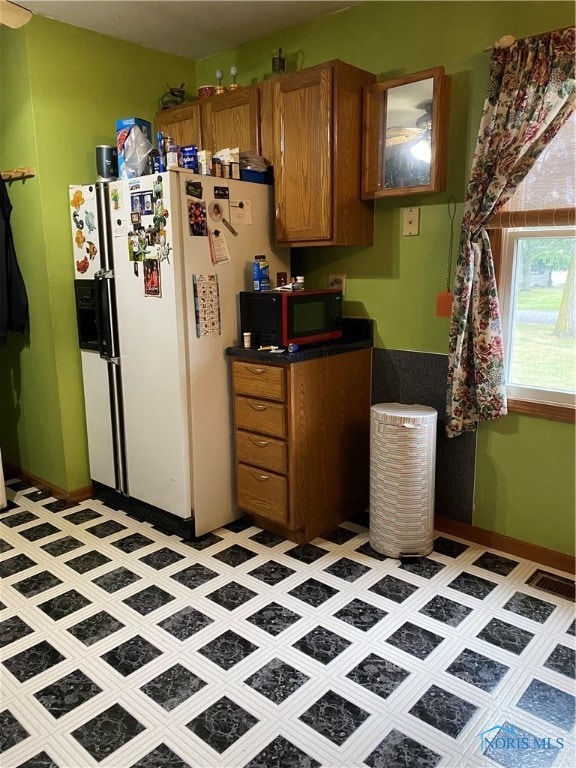 kitchen with tile patterned floors and white refrigerator