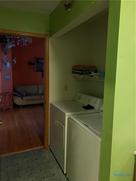 laundry room featuring hardwood / wood-style floors and washer and dryer