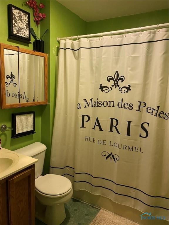 bathroom with vanity, a shower with shower curtain, and toilet