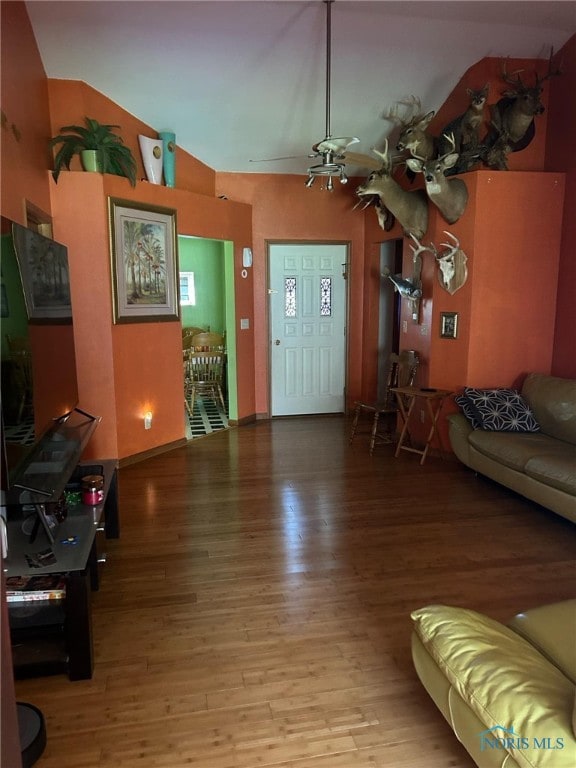 living room featuring lofted ceiling and wood-type flooring