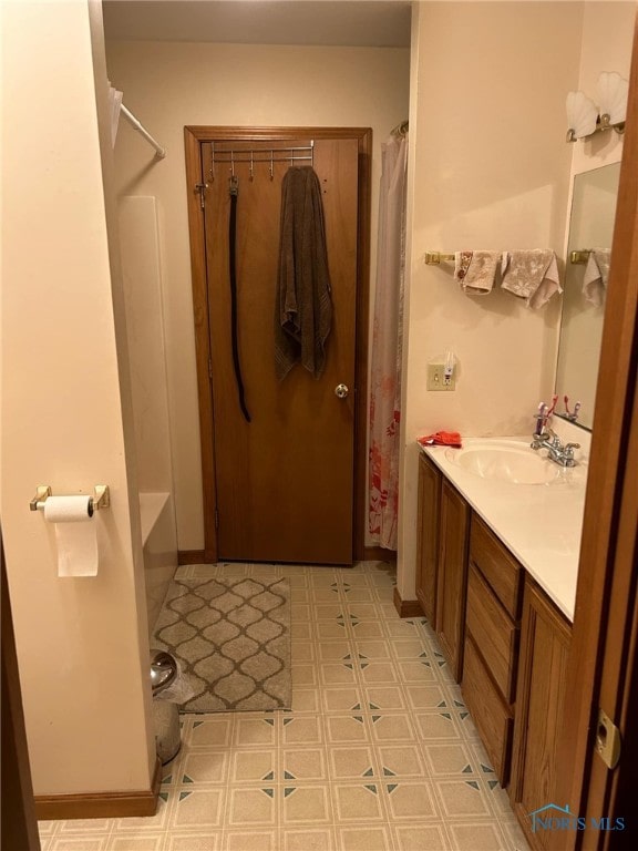 bathroom featuring shower / bath combination with curtain, vanity, and tile patterned floors