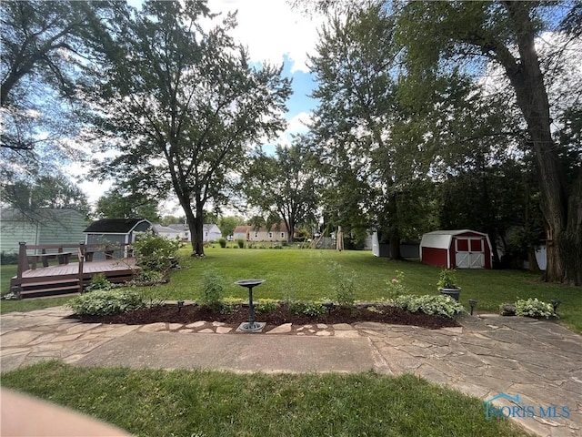 view of yard featuring a shed and a wooden deck