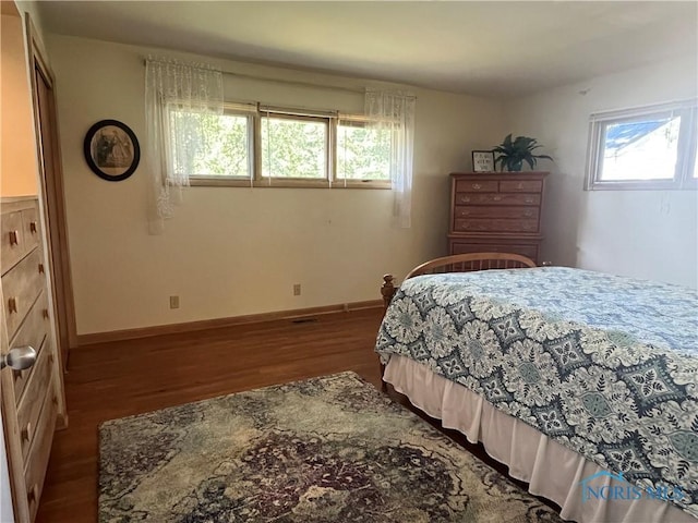 bedroom featuring hardwood / wood-style floors and multiple windows