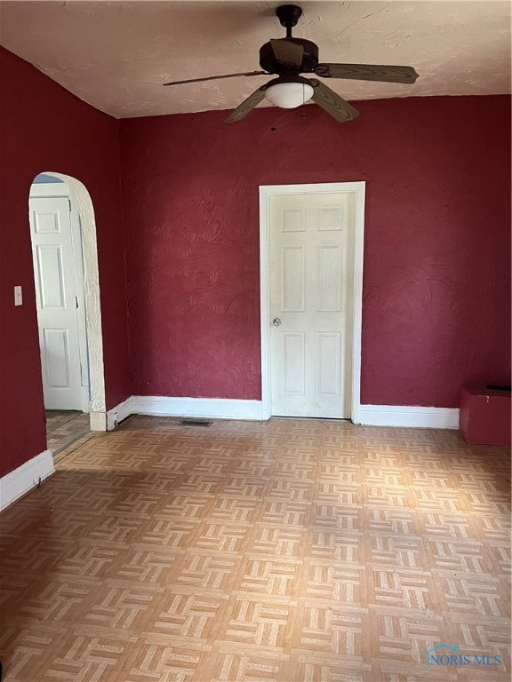 empty room featuring light parquet flooring and ceiling fan