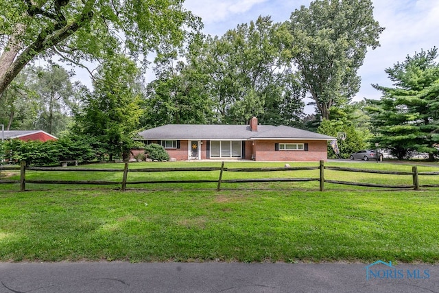 ranch-style home with a front lawn