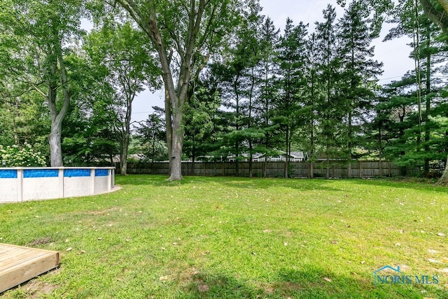 view of yard with a fenced in pool