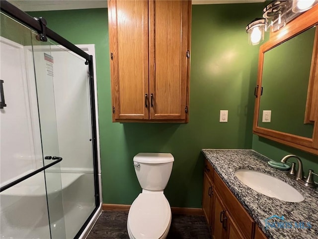 bathroom featuring walk in shower, vanity, and toilet