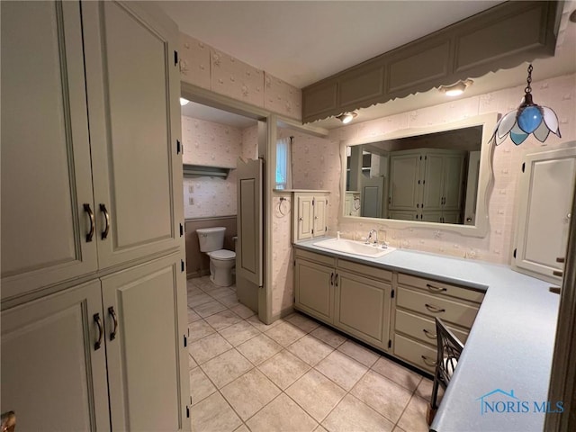 bathroom with tile patterned flooring, vanity, and toilet