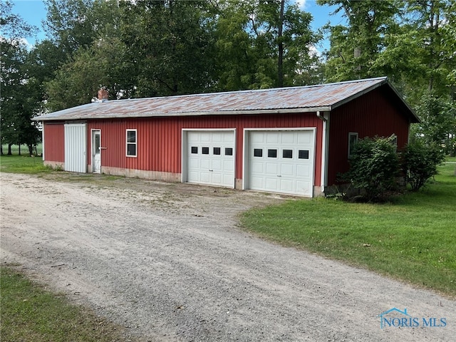 garage featuring a lawn