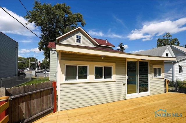 back of property with a wooden deck