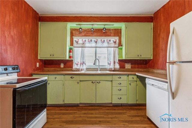 kitchen featuring green cabinets, dark hardwood / wood-style flooring, white appliances, and sink