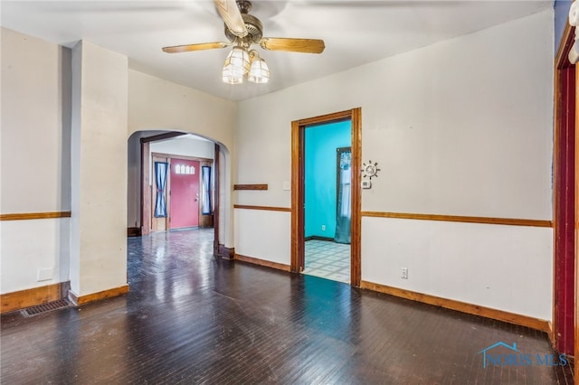 spare room featuring dark hardwood / wood-style floors and ceiling fan