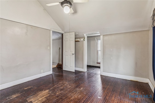 unfurnished bedroom with dark wood-type flooring, ceiling fan, and lofted ceiling