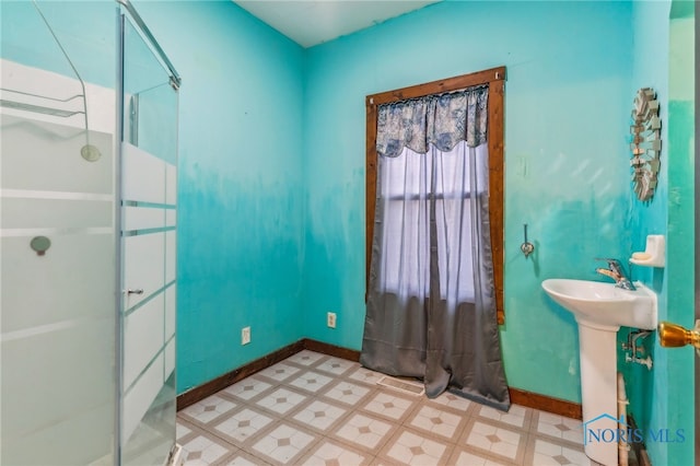 bathroom with walk in shower and sink