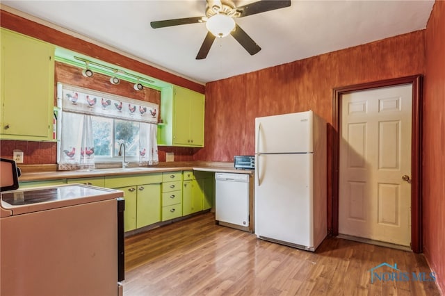 kitchen with white appliances, sink, green cabinetry, ceiling fan, and light hardwood / wood-style floors