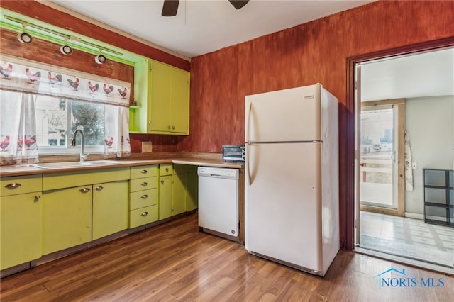 kitchen featuring white appliances, dark hardwood / wood-style floors, ceiling fan, and sink