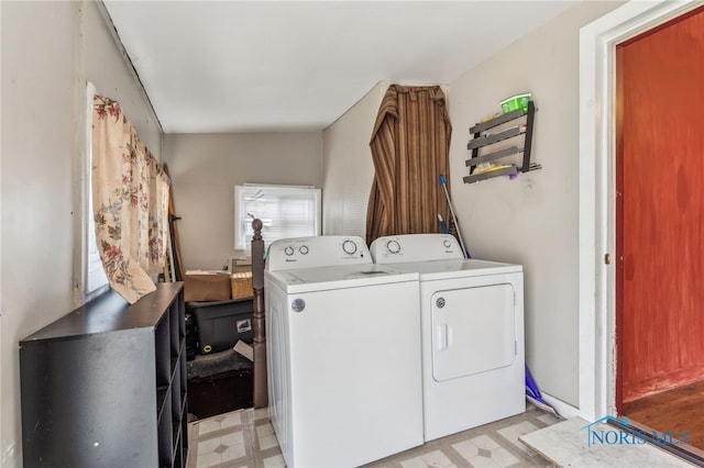 clothes washing area featuring separate washer and dryer