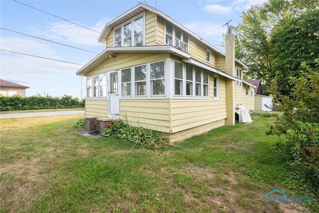 view of side of home with a lawn