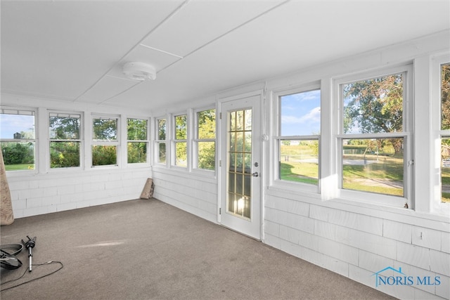 unfurnished sunroom with plenty of natural light