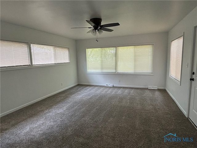 unfurnished room with carpet floors, plenty of natural light, and ceiling fan