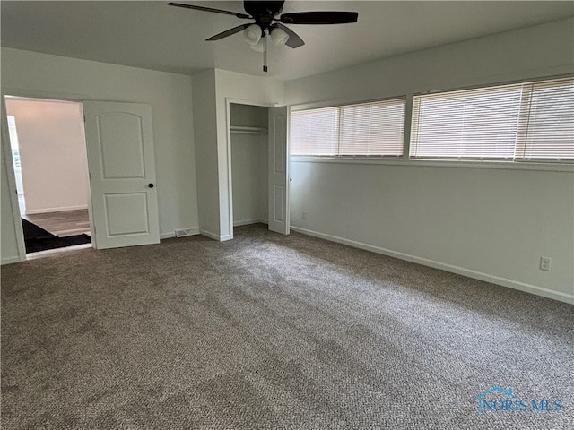 unfurnished bedroom featuring ceiling fan, a closet, and carpet flooring