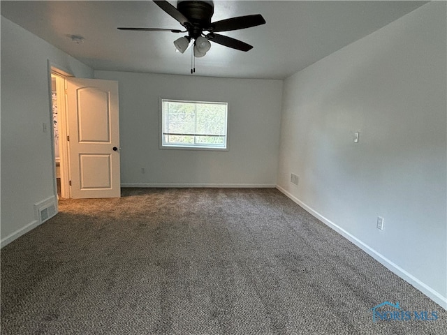 carpeted spare room featuring ceiling fan