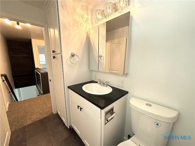 bathroom with tile patterned flooring, toilet, and vanity