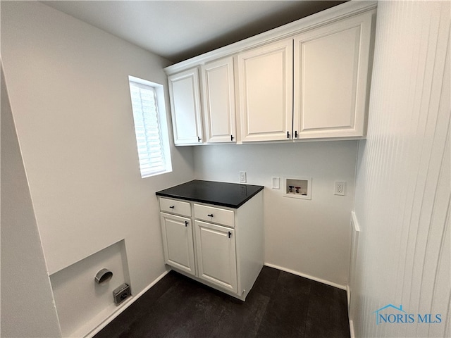 laundry area with dark hardwood / wood-style floors, hookup for a washing machine, and cabinets