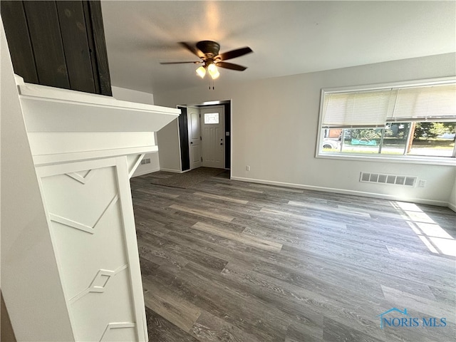 unfurnished living room with ceiling fan and wood-type flooring