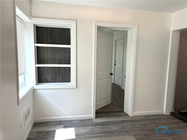 unfurnished room featuring dark wood-type flooring