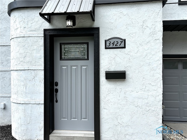 doorway to property featuring a garage