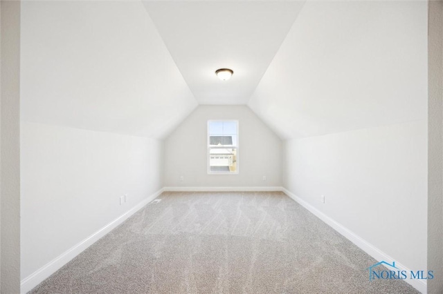 bonus room with baseboards, carpet flooring, and vaulted ceiling