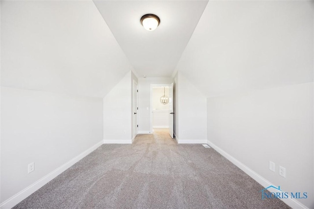 bonus room with vaulted ceiling, carpet, and baseboards