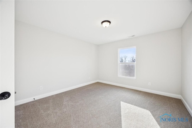 carpeted spare room with baseboards