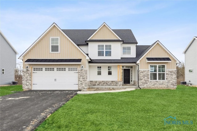 craftsman inspired home featuring roof with shingles, a standing seam roof, a front lawn, aphalt driveway, and metal roof