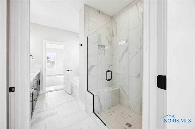 full bath featuring a marble finish shower, a garden tub, and vanity