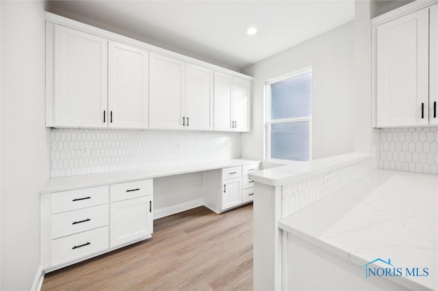 home office with recessed lighting, light wood finished floors, and built in study area