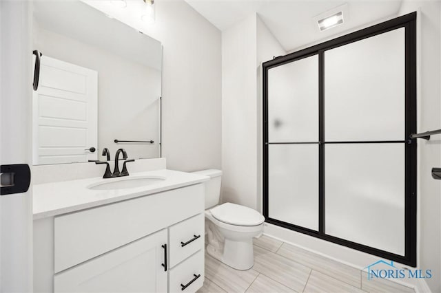 bathroom featuring visible vents, vanity, toilet, and a shower stall