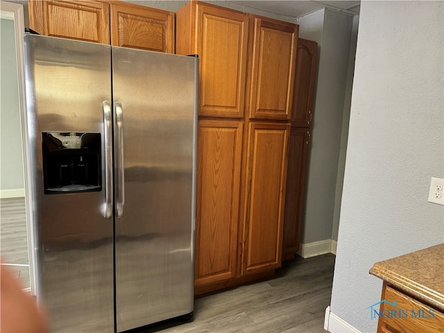 kitchen featuring light hardwood / wood-style floors and stainless steel fridge