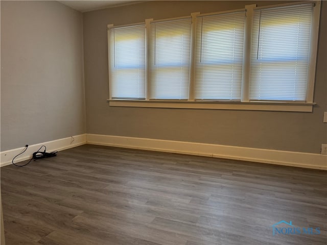 spare room with dark hardwood / wood-style floors