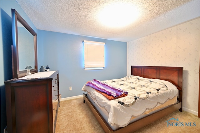 carpeted bedroom featuring a textured ceiling